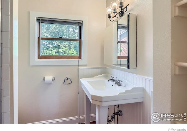 3116 47th St, Boulder, CO 80301 - bathroom with wainscoting, a chandelier, and healthy amount of natural light