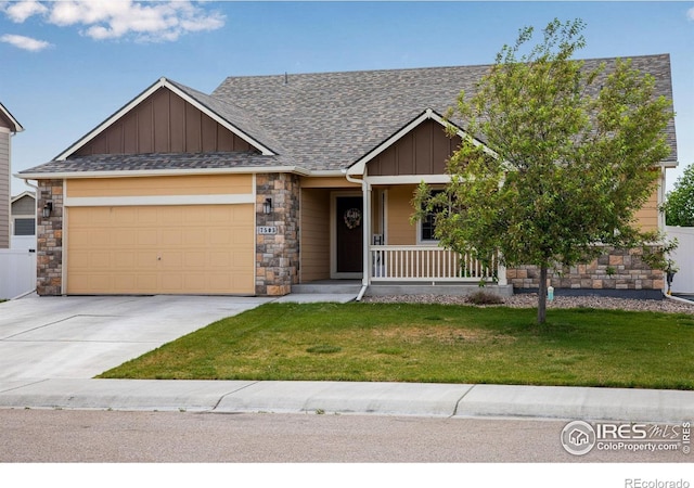 7505 Little Fox Ln, Wellington, CO 80549 - craftsman-style home with board and batten siding, a garage, a porch, and stone siding