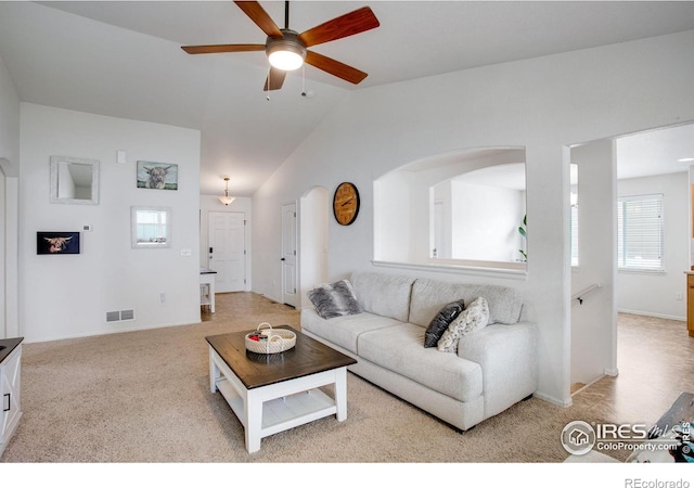 7505 Little Fox Ln, Wellington, CO 80549 - living area with a ceiling fan, vaulted ceiling, arched walkways, baseboards, and light carpet