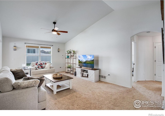 7505 Little Fox Ln, Wellington, CO 80549 - carpeted living area featuring arched walkways, a ceiling fan, baseboards, and high vaulted ceiling