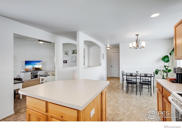 7505 Little Fox Ln, Wellington, CO 80549 - kitchen featuring electric stove, a chandelier, light countertops, a kitchen island, and decorative light fixtures