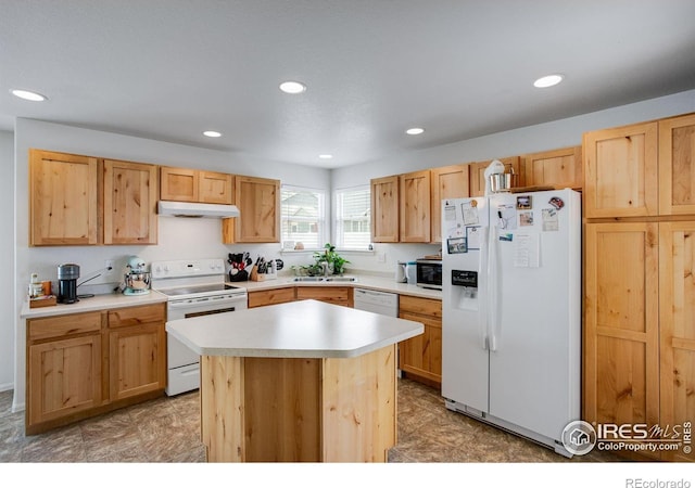 7505 Little Fox Ln, Wellington, CO 80549 - kitchen with white appliances, under cabinet range hood, light countertops, recessed lighting, and a sink