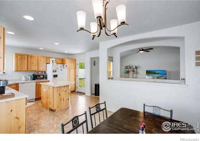 7505 Little Fox Ln, Wellington, CO 80549 - kitchen with white appliances, a ceiling fan, light countertops, arched walkways, and light brown cabinets