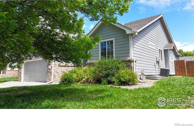374 Blue Azurite Ave, Loveland, CO 80537 - view of front of property featuring brick siding, driveway, a garage, and central air condition unit