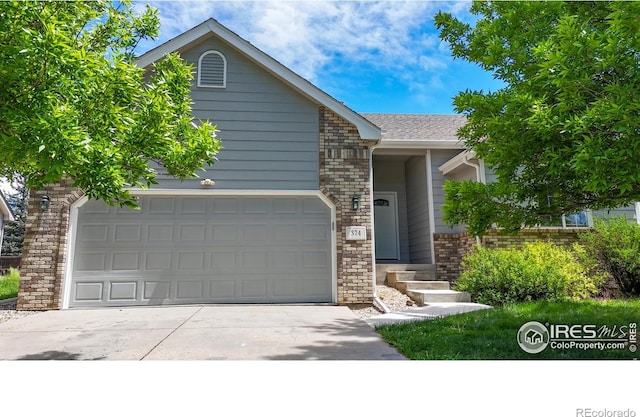 374 Blue Azurite Ave, Loveland, CO 80537 - view of front facade with concrete driveway, a garage, and brick siding