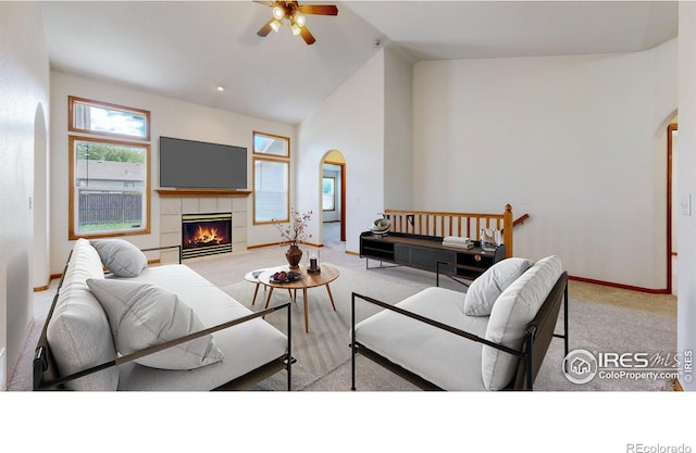374 Blue Azurite Ave, Loveland, CO 80537 - living room featuring arched walkways, ceiling fan, carpet flooring, lofted ceiling, and a fireplace