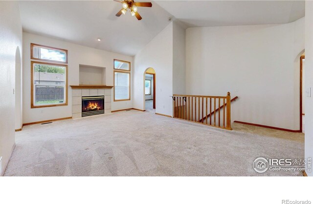 374 Blue Azurite Ave, Loveland, CO 80537 - unfurnished living room with arched walkways, carpet floors, healthy amount of natural light, and high vaulted ceiling