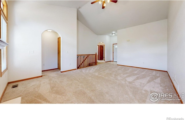 374 Blue Azurite Ave, Loveland, CO 80537 - carpeted spare room featuring arched walkways, a ceiling fan, high vaulted ceiling, and baseboards