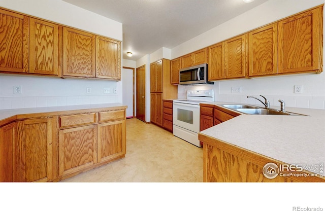 374 Blue Azurite Ave, Loveland, CO 80537 - kitchen with white electric range, stainless steel microwave, a sink, and light countertops