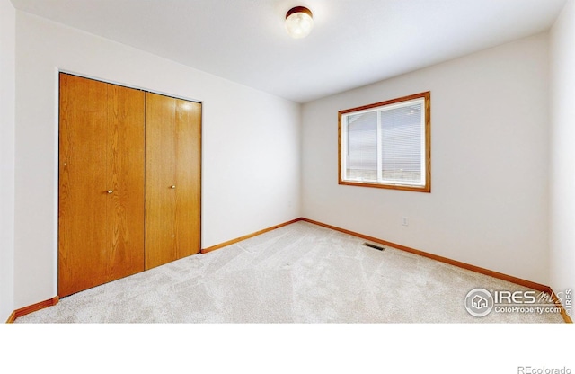 374 Blue Azurite Ave, Loveland, CO 80537 - unfurnished bedroom with carpet, baseboards, and a closet