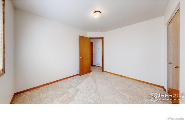 374 Blue Azurite Ave, Loveland, CO 80537 - unfurnished bedroom with carpet flooring, a closet, and baseboards