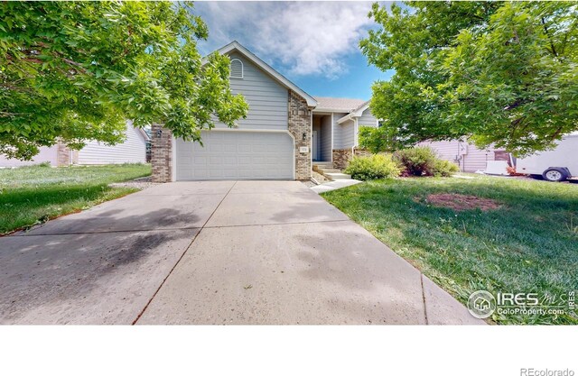 374 Blue Azurite Ave, Loveland, CO 80537 - view of front of house with driveway, a garage, a front lawn, and brick siding