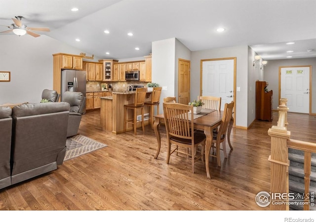 1918 Lily Dr, Loveland, CO 80537 - dining room featuring ceiling fan, light wood-style flooring, lofted ceiling, and recessed lighting