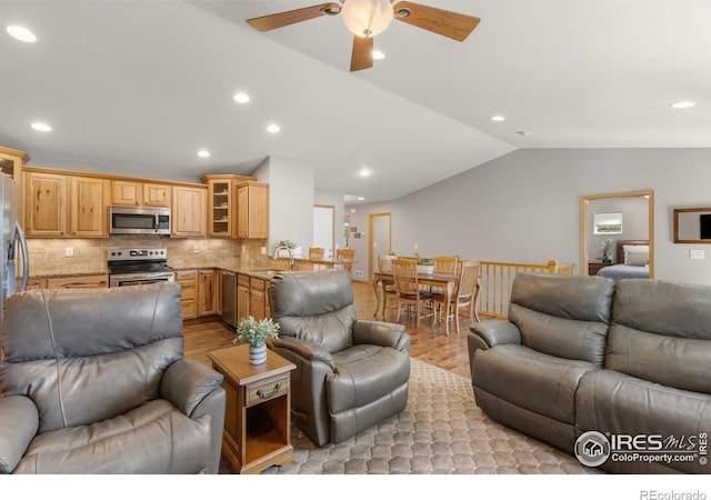 1918 Lily Dr, Loveland, CO 80537 - living room featuring light wood finished floors, vaulted ceiling, ceiling fan, and recessed lighting