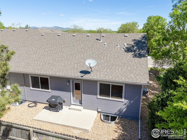 1918 Lily Dr, Loveland, CO 80537 - rear view of house featuring a patio area, a shingled roof, and central AC unit