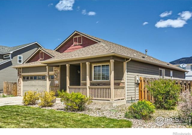 4134 Cypress Ridge Ln, Wellington, CO 80549 - view of front facade with a porch, fence, driveway, and an attached garage