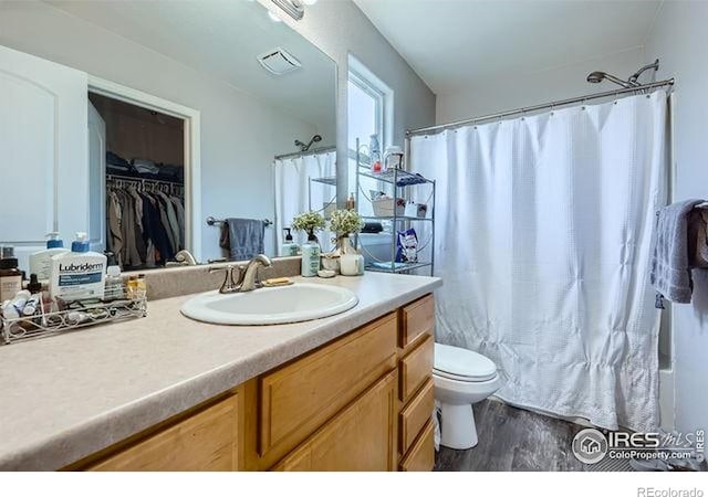 4134 Cypress Ridge Ln, Wellington, CO 80549 - full bath with wood finished floors, vanity, and toilet