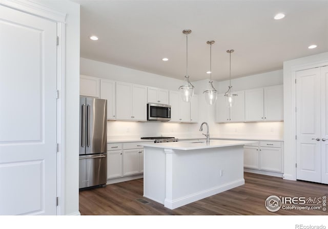 197 Liberty St, Erie, CO 80516 - kitchen featuring appliances with stainless steel finishes, dark wood-style floors, white cabinetry, recessed lighting, and light countertops