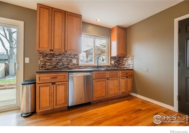 110 Lucerne Dr, Lafayette, CO 80026 - kitchen with dishwasher, a sink, brown cabinets, light wood-type flooring, and recessed lighting