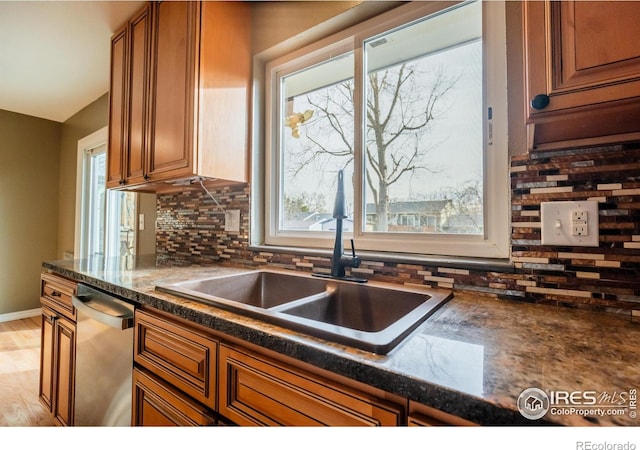 110 Lucerne Dr, Lafayette, CO 80026 - kitchen featuring dishwasher, brown cabinets, and plenty of natural light
