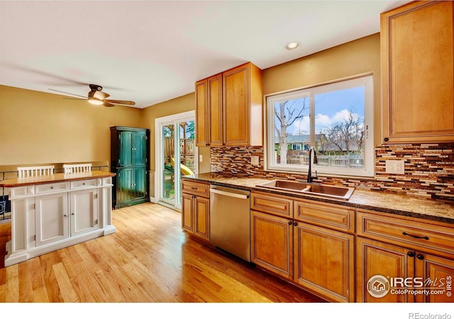 110 Lucerne Dr, Lafayette, CO 80026 - kitchen with stainless steel dishwasher, a sink, tasteful backsplash, light wood-style flooring, and ceiling fan