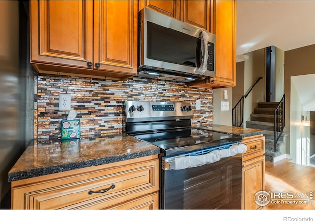 110 Lucerne Dr, Lafayette, CO 80026 - kitchen with appliances with stainless steel finishes, tasteful backsplash, and brown cabinets