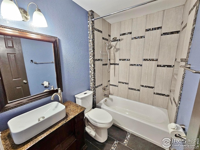 110 Lucerne Dr, Lafayette, CO 80026 - bathroom featuring a textured wall, tile patterned floors, toilet, washtub / shower combination, and vanity