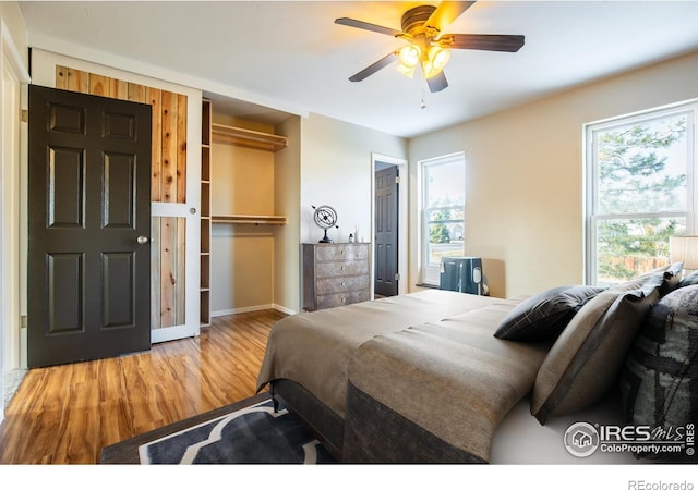 110 Lucerne Dr, Lafayette, CO 80026 - bedroom featuring wood finished floors, multiple windows, baseboards, and ceiling fan