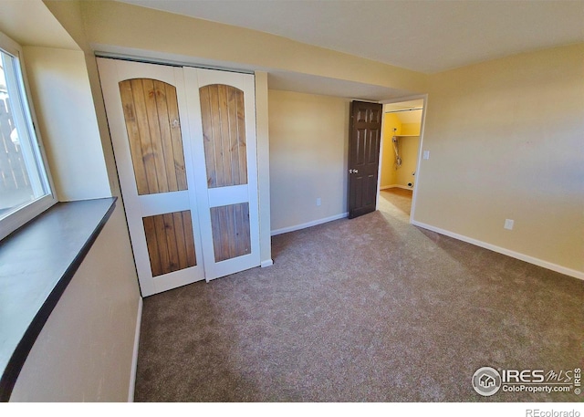 110 Lucerne Dr, Lafayette, CO 80026 - unfurnished bedroom featuring carpet flooring, baseboards, and a closet