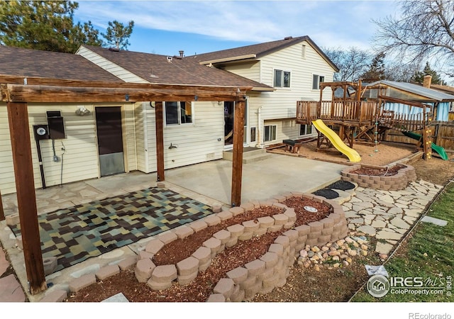 110 Lucerne Dr, Lafayette, CO 80026 - rear view of house with a playground, roof with shingles, a patio, and fence