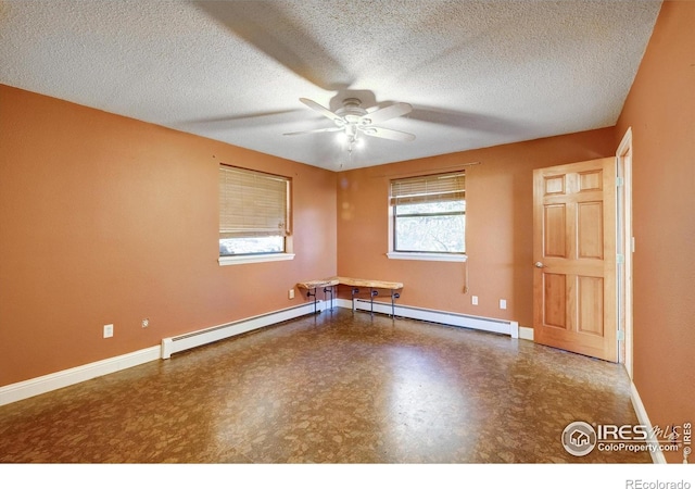 33090 Janelle Cir, Golden, CO 80403 - spare room with a baseboard radiator, a ceiling fan, baseboards, and a textured ceiling