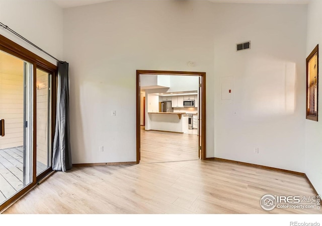 2962 Shadow Creek Dr Unit 306, Boulder, CO 80303 - empty room with light wood finished floors, baseboards, and a high ceiling
