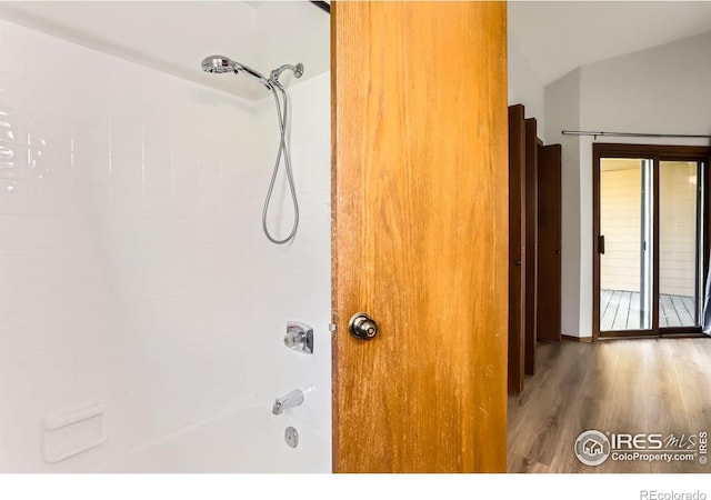 2962 Shadow Creek Dr Unit 306, Boulder, CO 80303 - bathroom featuring wood finished floors, shower / tub combination, and vaulted ceiling