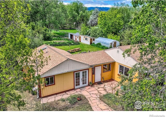 1047 Cherryvale Rd, Boulder, CO 80303 - view of front of house with french doors, roof with shingles, and a patio