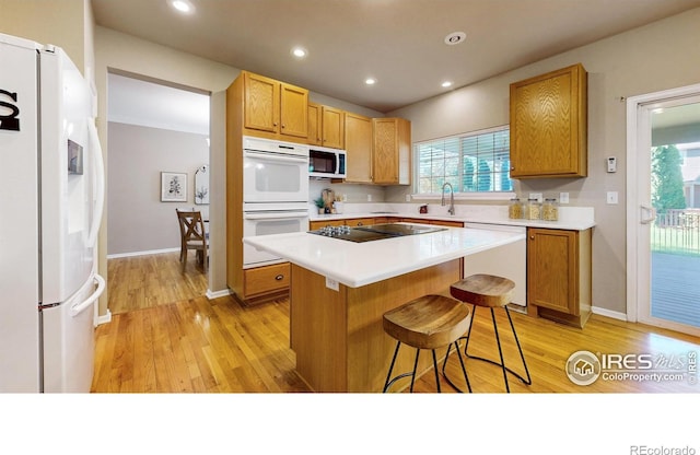 3221 Mesa Verde St, Fort Collins, CO 80525 - kitchen with white appliances, light wood finished floors, light countertops, a sink, and recessed lighting