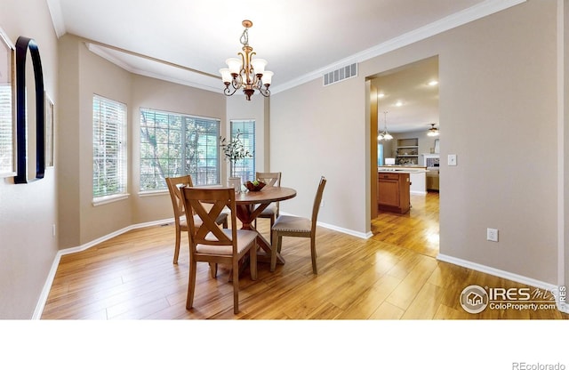 3221 Mesa Verde St, Fort Collins, CO 80525 - dining space featuring a chandelier, light wood-type flooring, ornamental molding, and baseboards