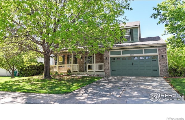 3221 Mesa Verde St, Fort Collins, CO 80525 - view of front of property with brick siding, driveway, a porch, a front lawn, and a garage