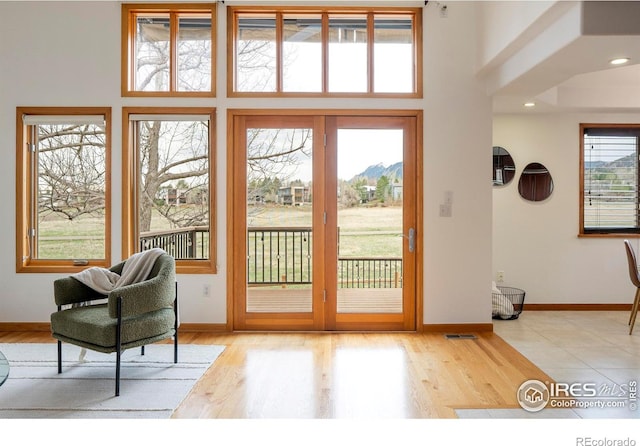 990 Utica Cir, Boulder, CO 80304 - doorway to outside featuring wood finished floors, a towering ceiling, and baseboards