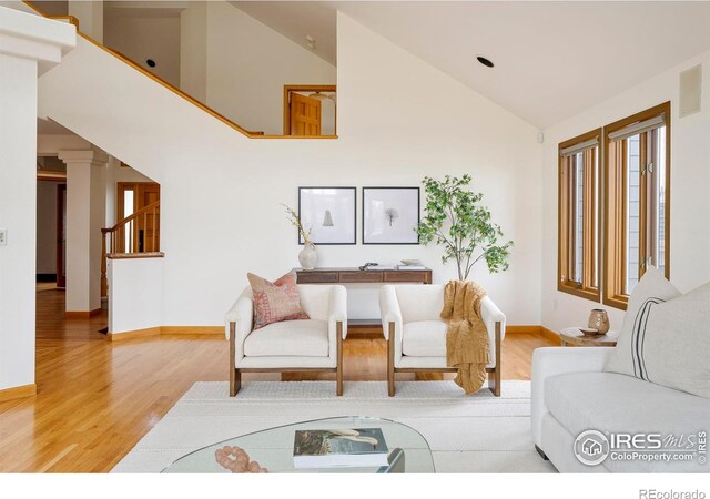 990 Utica Cir, Boulder, CO 80304 - living room with light wood-style flooring, baseboards, high vaulted ceiling, and stairway