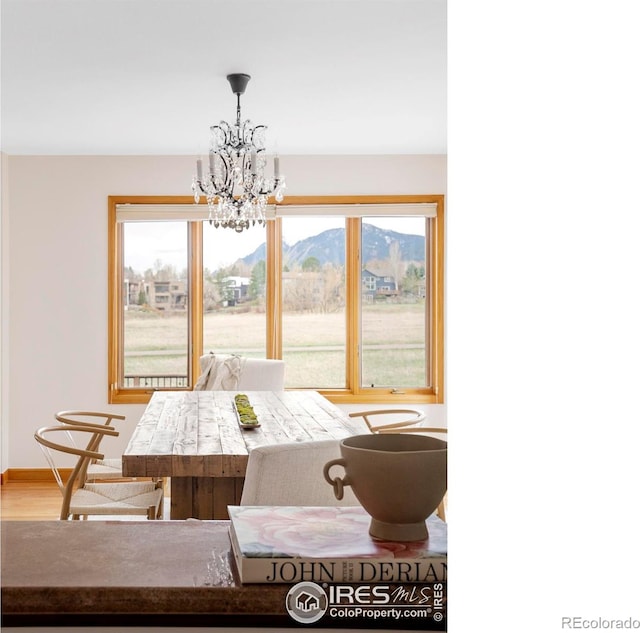 990 Utica Cir, Boulder, CO 80304 - dining space featuring a chandelier, healthy amount of natural light, wood finished floors, and a mountain view