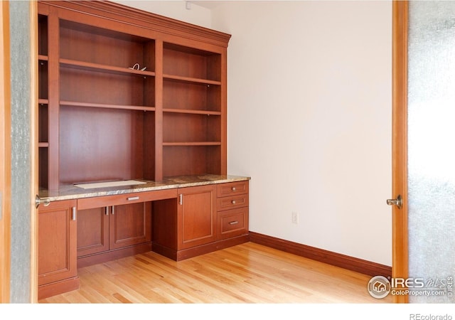 990 Utica Cir, Boulder, CO 80304 - unfurnished office featuring light wood finished floors, built in desk, and baseboards