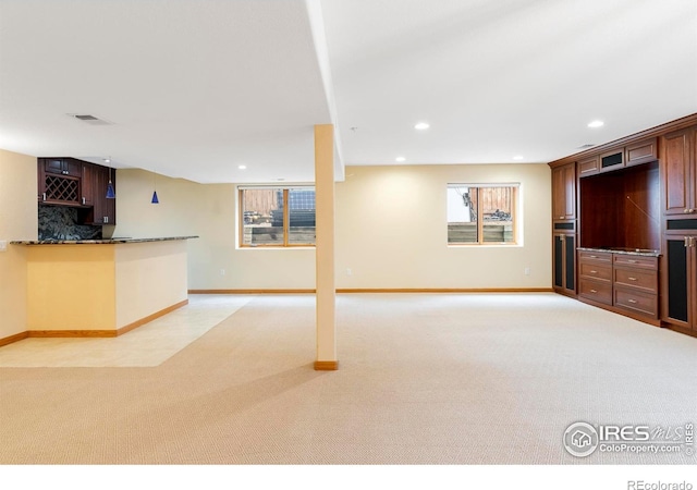 990 Utica Cir, Boulder, CO 80304 - unfurnished living room with light carpet, baseboards, recessed lighting, and bar area