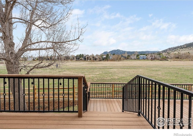 990 Utica Cir, Boulder, CO 80304 - wooden deck featuring a mountain view and a lawn