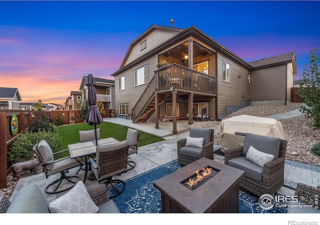 5524 Congressional Ct, Windsor, CO 80528 - back of property with a patio area, stairway, a fenced backyard, outdoor dining area, and a deck