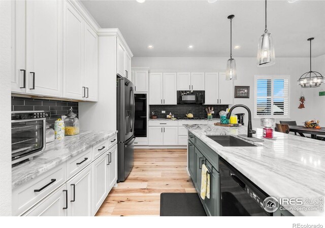 5524 Congressional Ct, Windsor, CO 80528 - kitchen with a sink, black appliances, white cabinetry, and recessed lighting