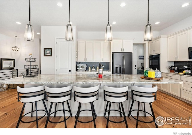 5524 Congressional Ct, Windsor, CO 80528 - kitchen featuring fridge with ice dispenser, black oven, decorative backsplash, recessed lighting, and white cabinets