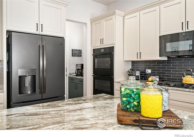 5524 Congressional Ct, Windsor, CO 80528 - kitchen with black appliances, light stone counters, and decorative backsplash