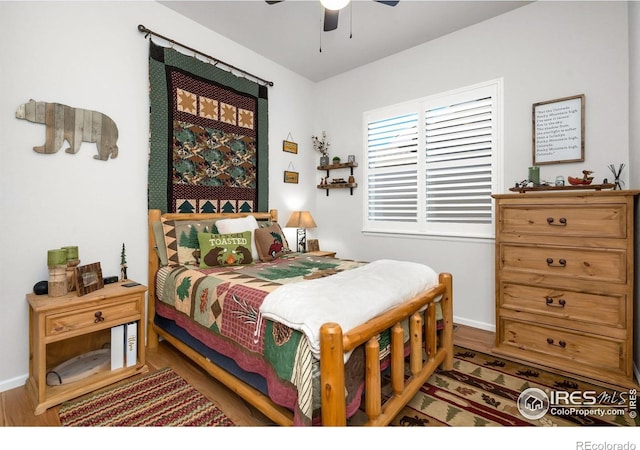 5524 Congressional Ct, Windsor, CO 80528 - bedroom featuring wood finished floors, baseboards, and a ceiling fan