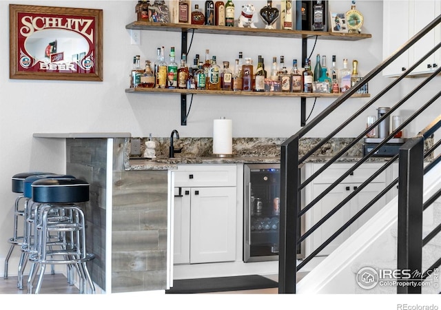5524 Congressional Ct, Windsor, CO 80528 - indoor wet bar featuring beverage cooler and stairway