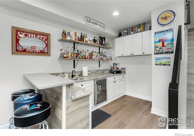 5524 Congressional Ct, Windsor, CO 80528 - indoor wet bar featuring beverage cooler, light wood finished floors, baseboards, and recessed lighting